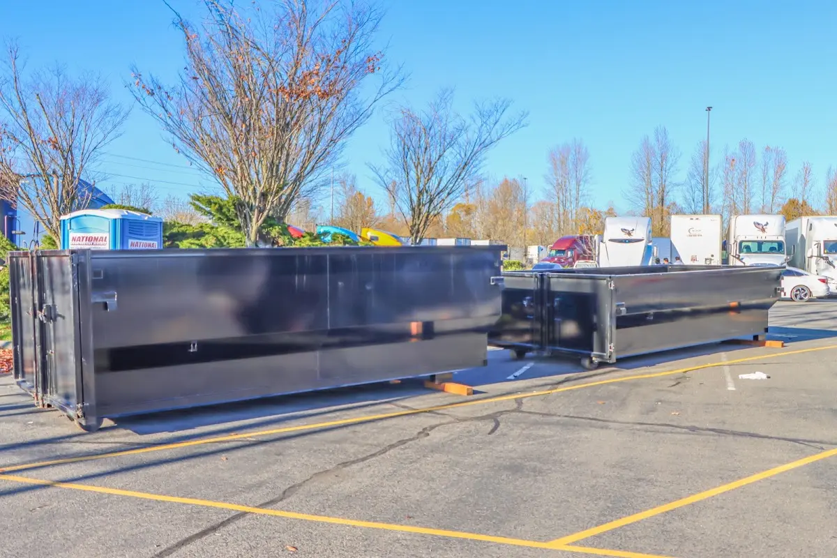 Professional dumpster rental service with roll-off container on residential driveway in Deptford